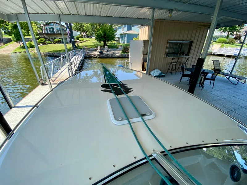 Slide: The Image of 1999 Checkmate 259 Convincer boat docked under a covered marina. - 8