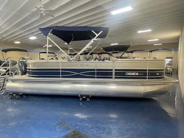 The Image of 2019 South Bay 224 RS 3.0 pontoon boat in indoor showroom. - 0