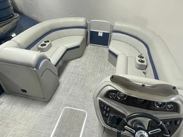 Slide: The Image of 2019 South Bay 224 RS 3.0 pontoon boat interior with plush seating and modern dashboard. - 3