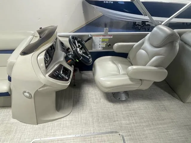 Slide: The Image of 2019 South Bay 224 RS 3.0 boat interior with steering console and captain's chair. - 6
