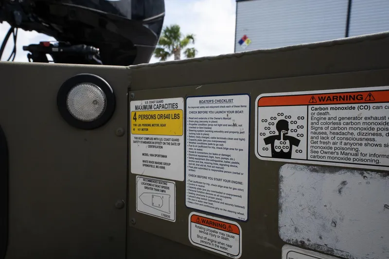 Slide: The Image of Safety labels on 2023 Tracker Grizzly 1654 T Sportsman boat, highlighting capacity and carbon monoxide warnings. - 11