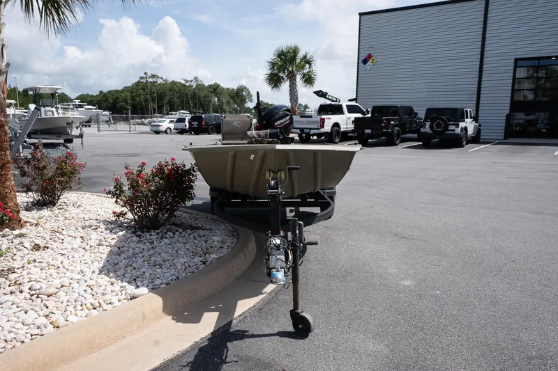 Slide: The Image of 2023 Tracker Grizzly 1654 T Sportsman boat parked in a dealership lot. - 4