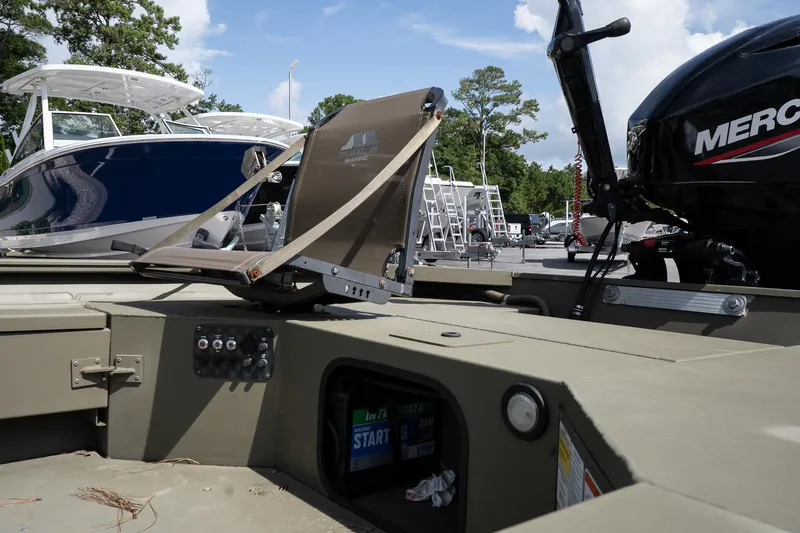 Slide: The Image of 2023 Tracker Grizzly 1654 T Sportsman boat with Mercury engine, parked outdoors. - 8