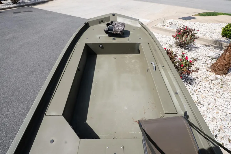 Slide: The Image of 2023 Tracker Grizzly 1654 T Sportsman boat interior, showing spacious deck and seating area. - 9