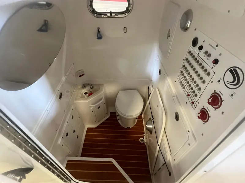 Slide: The Image of 2020 Edgewater 320CC boat interior with toilet, sink, and control panel. - 11