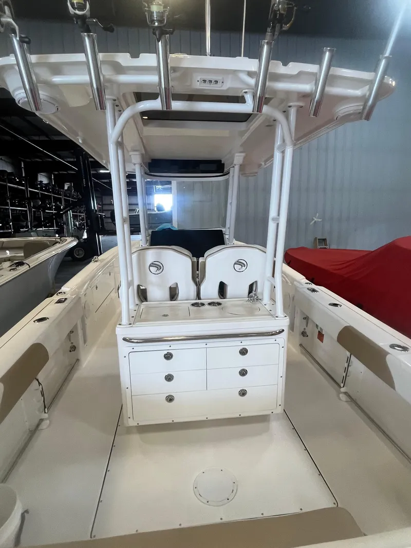 Slide: The Image of 2020 Edgewater 320CC boat interior with seating and storage compartments. - 16