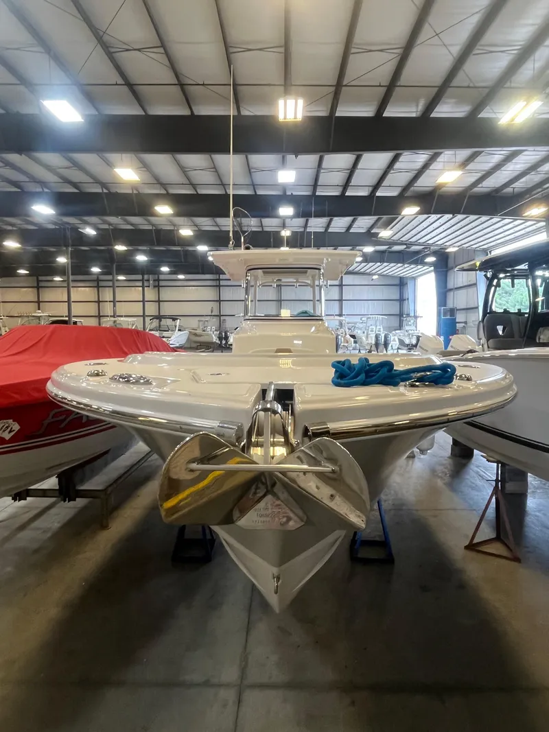 Slide: The Image of 2020 Edgewater 320CC boat in indoor storage, front view with anchor and blue rope. - 3