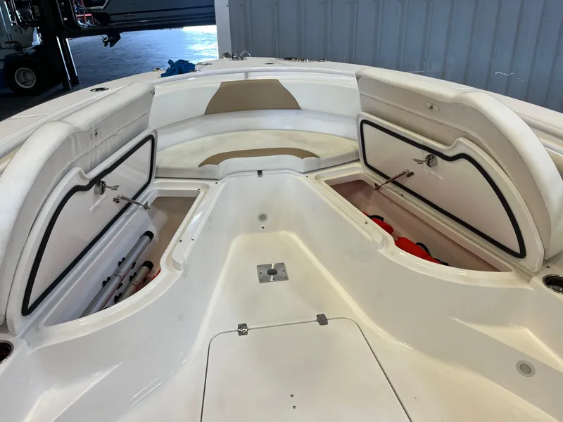 Slide: The Image of 2020 Edgewater 320CC boat interior with open storage compartments and seating area. - 6