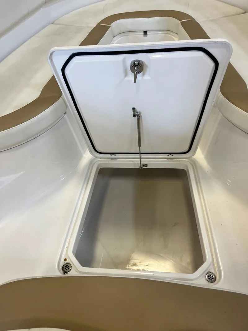 Slide: The Image of Open storage compartment on 2020 Edgewater 320CC boat, featuring a secure latch and spacious interior. - 7