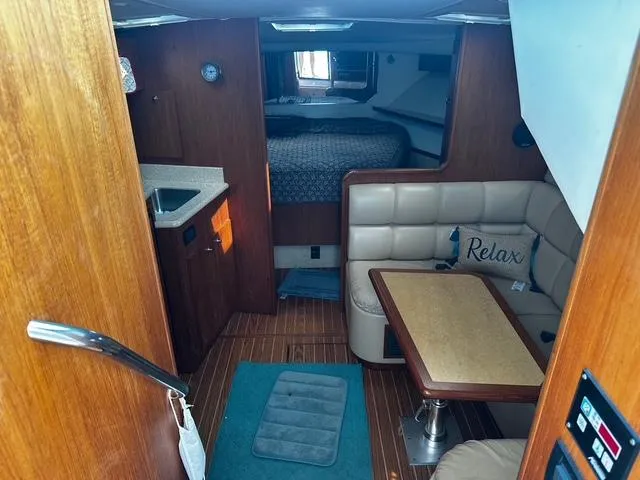 Slide: The Image of Engine compartment of a 2003 Tiara Yachts 3500 Express, featuring red engine components and hoses. - 13