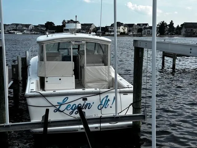 Slide: The Image of 2003 Tiara Yachts 3500 Express docked, showcasing sleek design and spacious deck. - 23