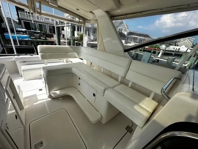 Slide: The Image of 2003 Tiara Yachts 3500 Express docked, rear view with "Leggin It!" text on the stern. - 3
