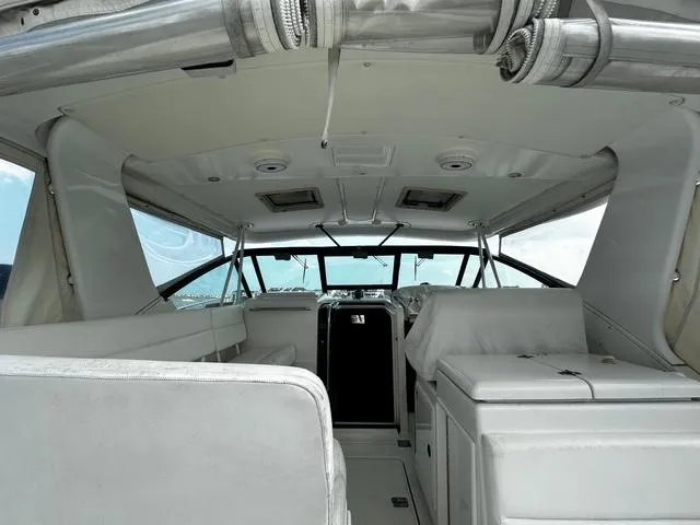 Slide: The Image of 2003 Tiara Yachts 3500 Express interior with helm, seating, and ocean view. - 7