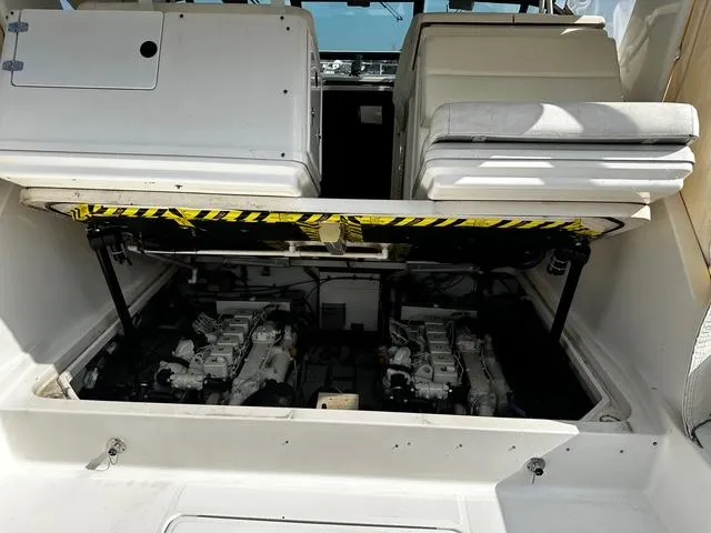 Slide: The Image of 2003 Tiara Yachts 3500 Express boat interior with white seating and spacious deck. - 8