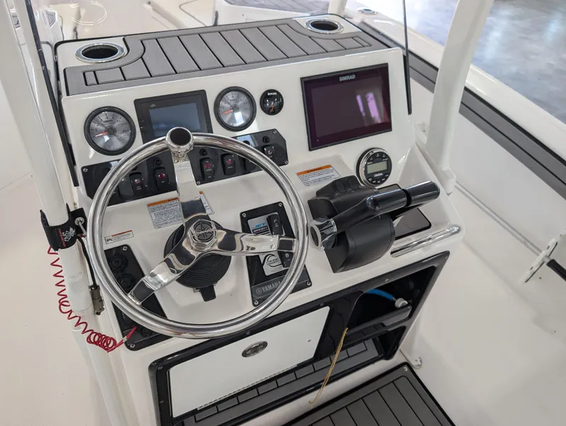 Slide: The Image of 2018 Yamaha Boats 210 FSH Sport dashboard with steering wheel and controls. - 3