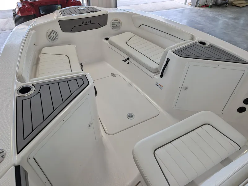 Slide: The Image of 2018 Yamaha Boats 210 FSH Sport interior with seating and storage compartments. - 4