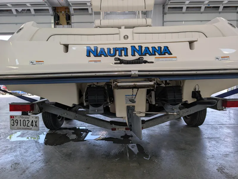 Slide: The Image of Rear view of 2018 Yamaha Boats 210 FSH Sport on trailer in garage. - 6
