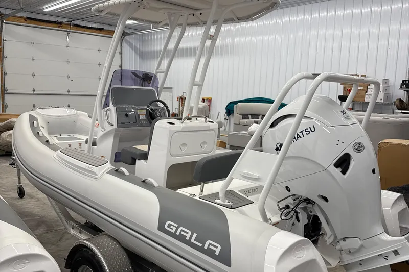 Slide: The Image of 2026 Gala V500 boat with Tohatsu engine in a garage setting. - 13