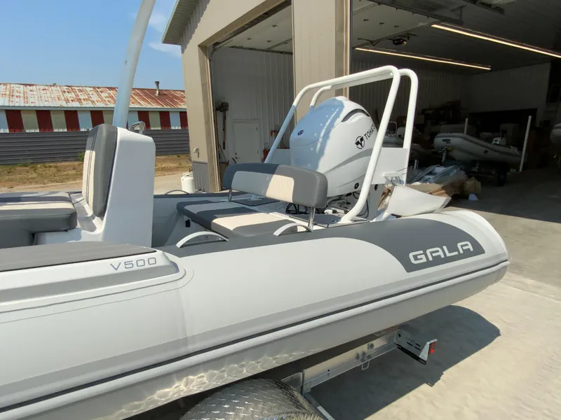 Slide: The Image of 2026 Gala V500 inflatable boat with outboard motor in a garage setting. - 3