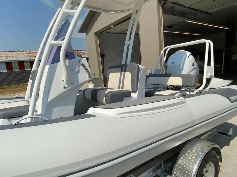 Slide: The Image of 2026 Gala V500 boat with sleek design, modern seating, and powerful engine in a sunny setting. - 4