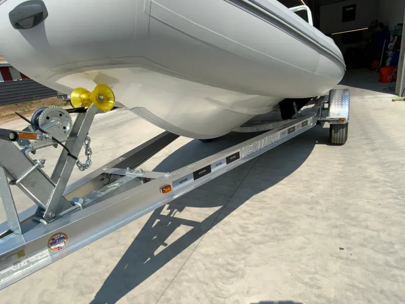 Slide: The Image of Boat on trailer, Gala V500 model, 2026, parked on concrete surface. - 6