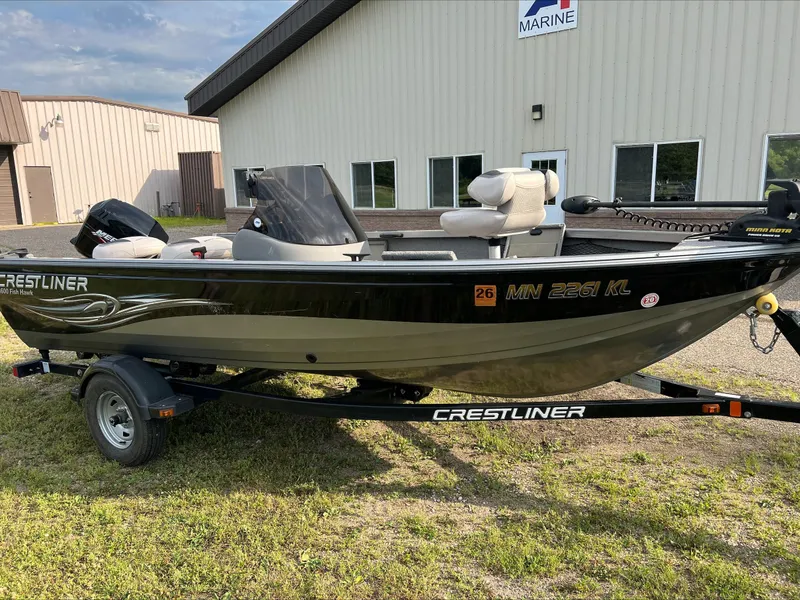 Slide: The Image of 2009 Crestliner Fish Hawk 1600 SC boat on trailer, parked outside a marine building. - 3