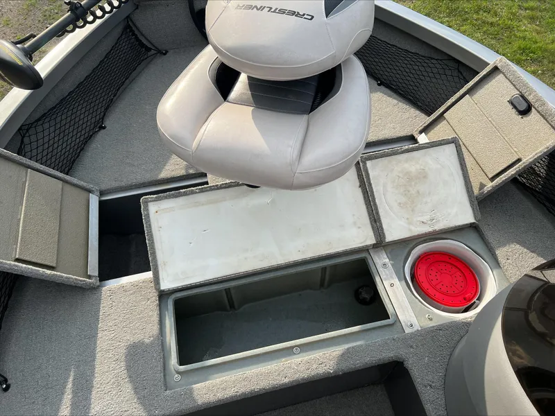 Slide: The Image of 2009 Crestliner Fish Hawk 1600 SC boat interior with storage compartments and seating. - 6