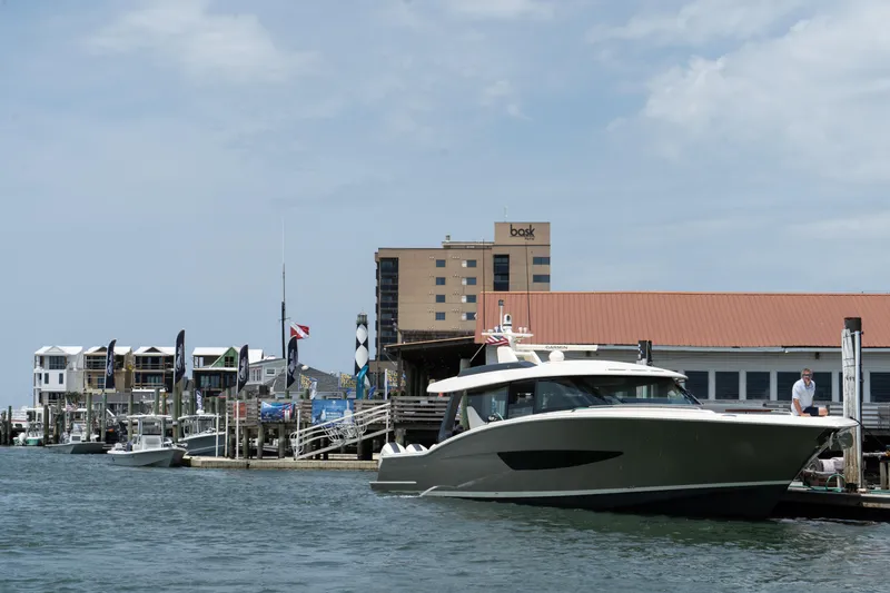 Slide: The Image of 2025 Scout 670 LXS docked at a marina with waterfront buildings in the background. - 3