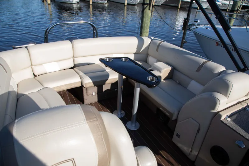 Slide: The Image of Luxurious seating area on a 2018 Godfrey 255 ULB boat with a sleek table. - 10