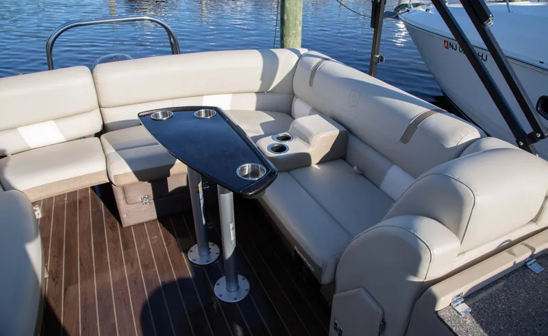 Slide: The Image of Luxurious seating area on 2018 Godfrey 255 ULB boat with sleek table and cup holders. - 11