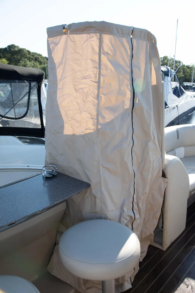 Slide: The Image of 2018 Godfrey 255 ULB boat with covered helm station and seating area. - 16