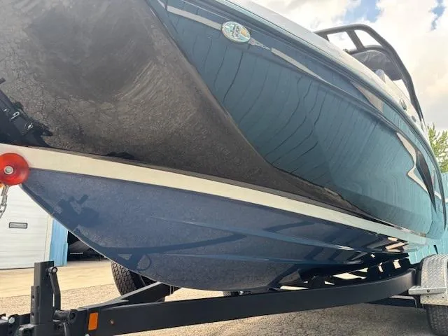 Slide: The Image of 2023 Yamaha Boats 222SD on trailer, showcasing sleek blue hull design. - 2