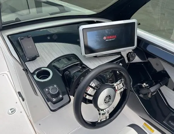 Slide: The Image of 2023 Yamaha Boats 222SD dashboard with steering wheel and touchscreen display. - 20