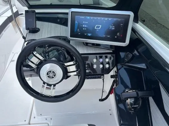 Slide: The Image of 2023 Yamaha Boats 222SD dashboard with steering wheel and touchscreen display. - 22