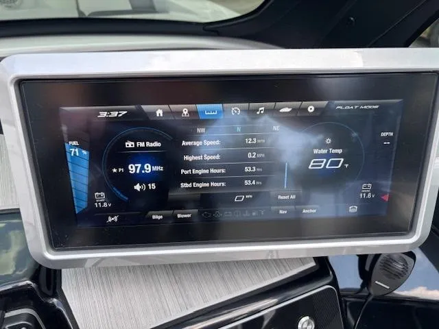 Slide: The Image of Dashboard display of 2023 Yamaha Boats 222SD showing speed, water temperature, and FM radio. - 23
