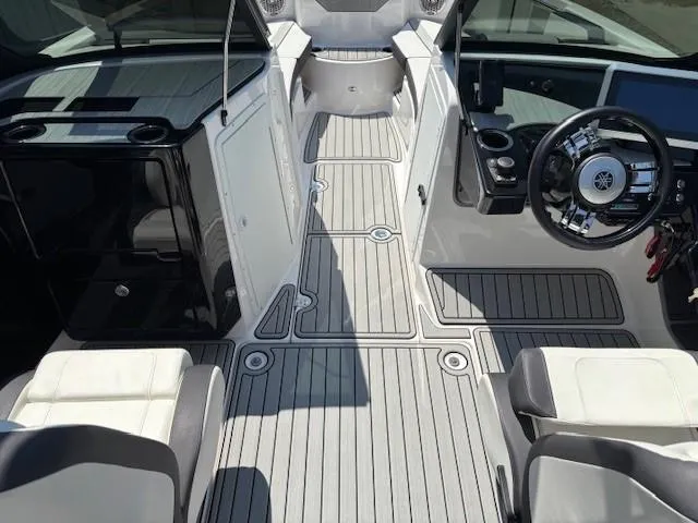 Slide: The Image of 2023 Yamaha Boats 222SD interior with sleek design, modern dashboard, and comfortable seating. - 25