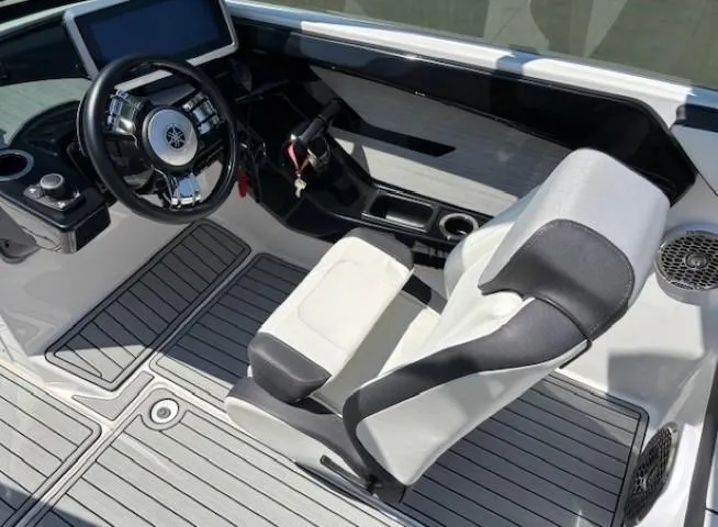 Slide: The Image of 2023 Yamaha Boats 222SD cockpit with modern steering and seating design. - 28