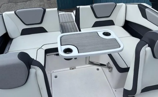Slide: The Image of 2023 Yamaha Boats 222SD interior with seating and table, featuring modern design and cup holders. - 34
