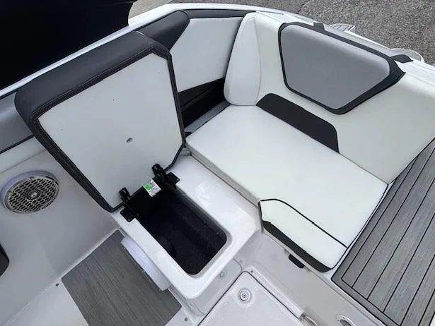 Slide: The Image of 2023 Yamaha Boats 222SD interior with open storage compartment and cushioned seating. - 37