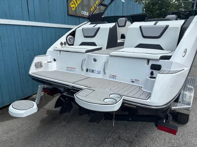Slide: The Image of 2023 Yamaha Boats 222SD, rear view, showcasing swim platform and seating. - 5