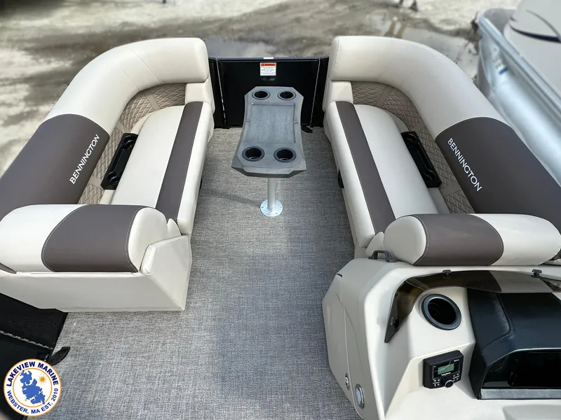 Slide: The Image of 2025 Bennington 22 SSR boat interior with beige and brown seating, cup holders, and console. - 5