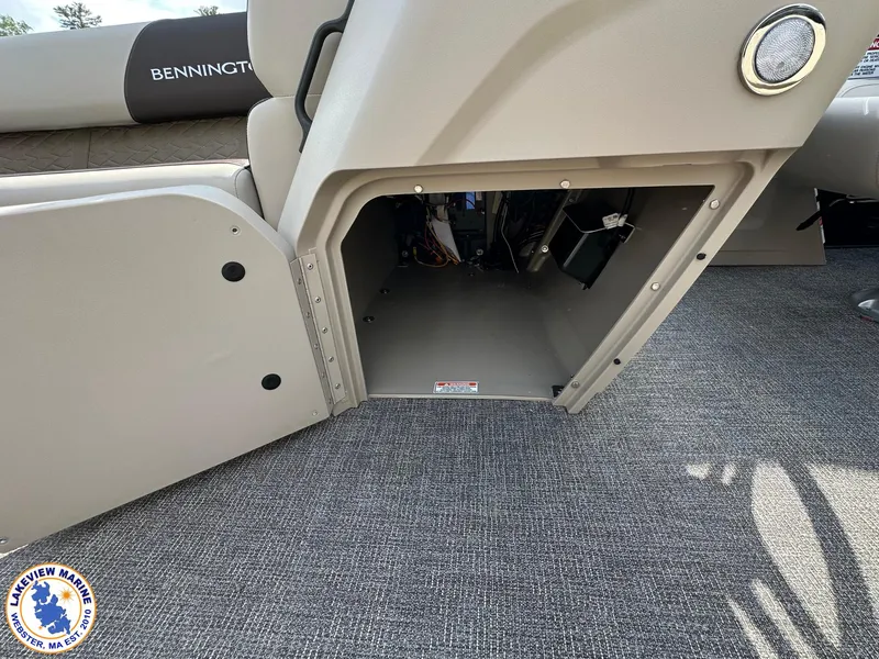 Slide: The Image of Interior storage compartment of 2025 Bennington 22 SSR pontoon boat, featuring carpeted flooring. - 9