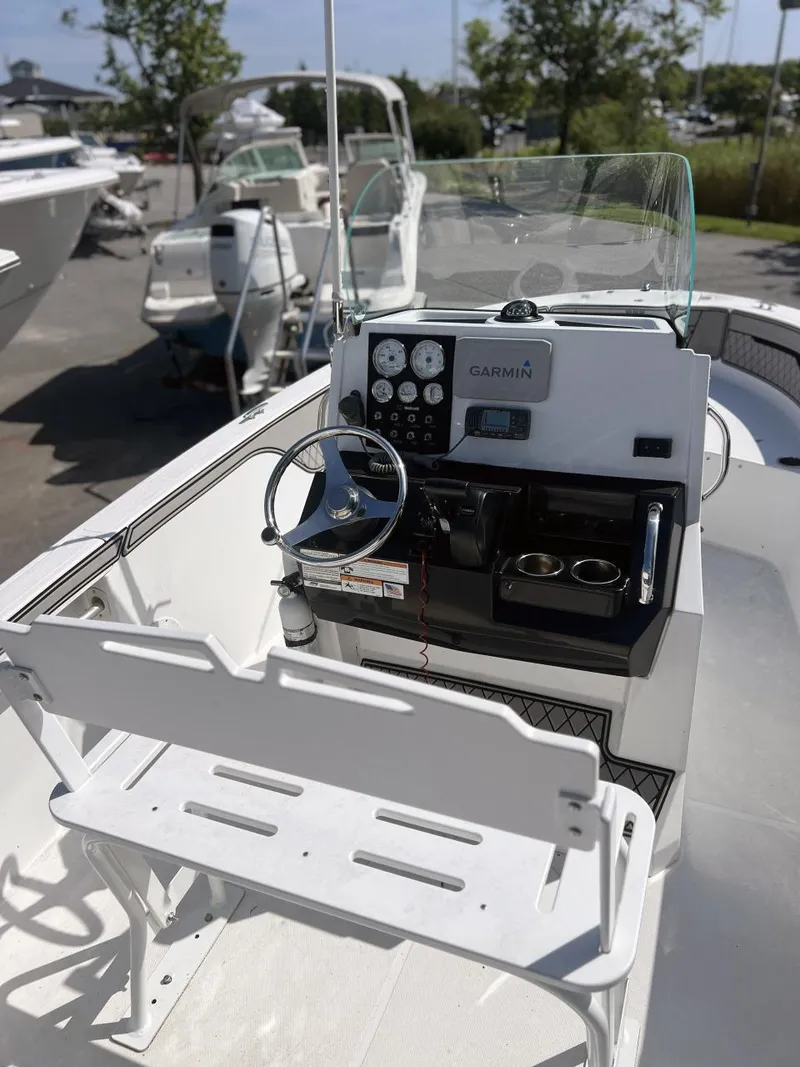 Slide: The Image of 2020 Wellcraft 182 Fishmaster boat dashboard with Garmin navigation system and steering wheel. - 11
