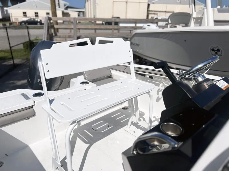 Slide: The Image of 2020 Wellcraft 182 Fishmaster boat interior with white seating and steering console. - 12
