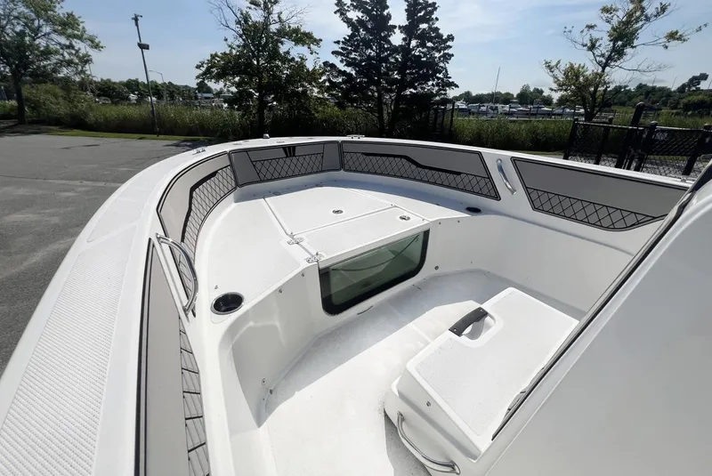 Slide: The Image of 2020 Wellcraft 182 Fishmaster boat interior with seating and storage, parked outdoors. - 21