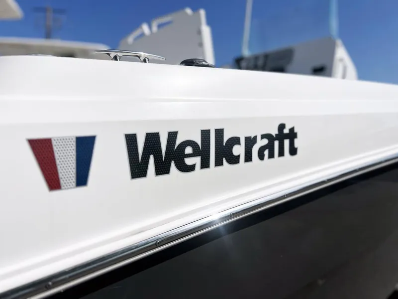 Slide: The Image of 2020 Wellcraft 182 Fishmaster boat logo on white hull, close-up view. - 8