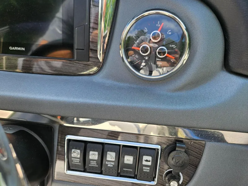 Slide: The Image of Dashboard of 2019 Chaparral 246 SSi boat with Garmin display and control switches. - 10