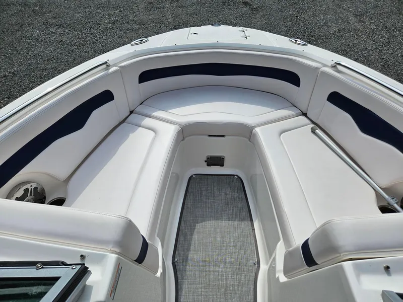 Slide: The Image of 2019 Chaparral 246 SSi boat interior with white and navy seating. - 12