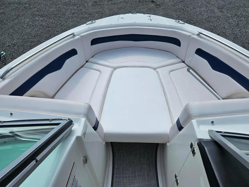 Slide: The Image of 2019 Chaparral 246 SSi boat interior with white and navy seating. - 13