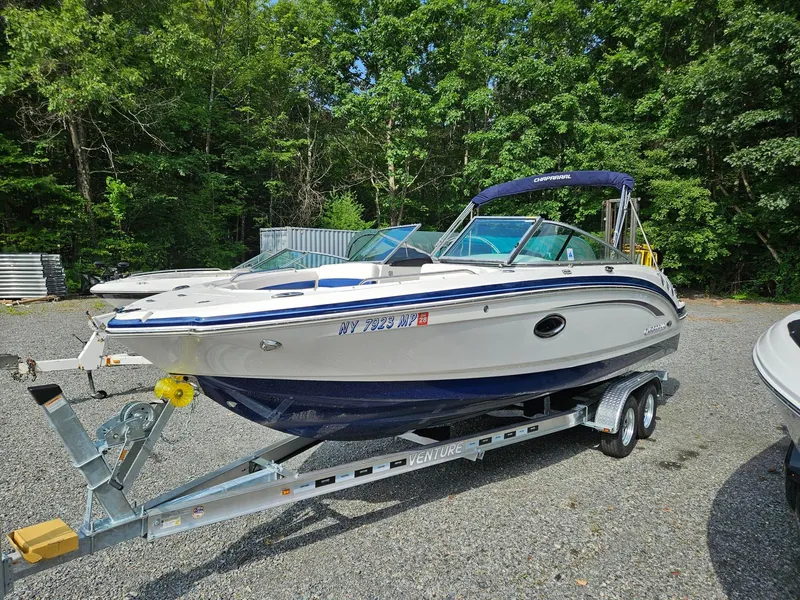 Slide: The Image of 2019 Chaparral 246 SSi boat on trailer, parked outdoors near trees. - 3